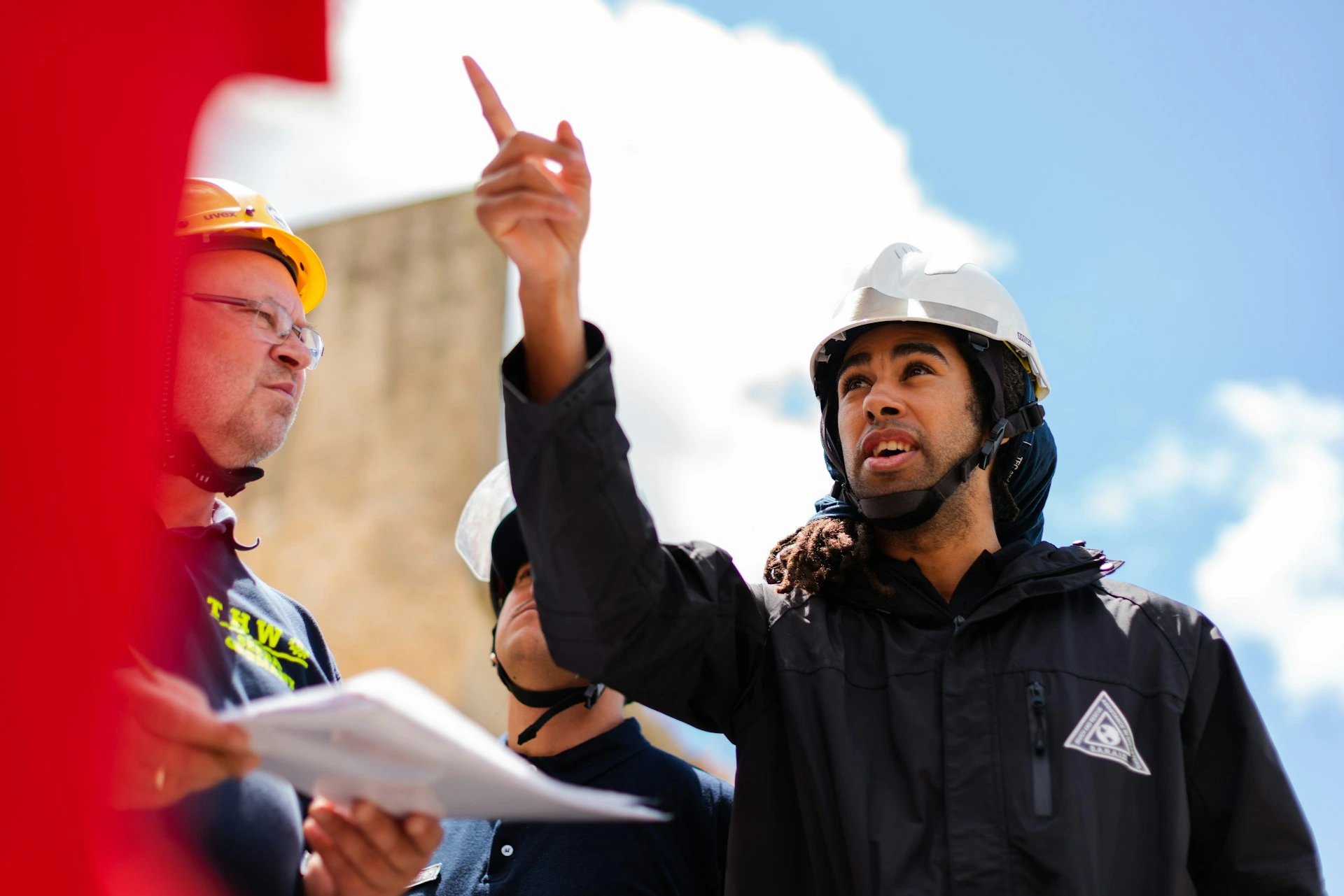 Project manager briefing a construction crew on site.